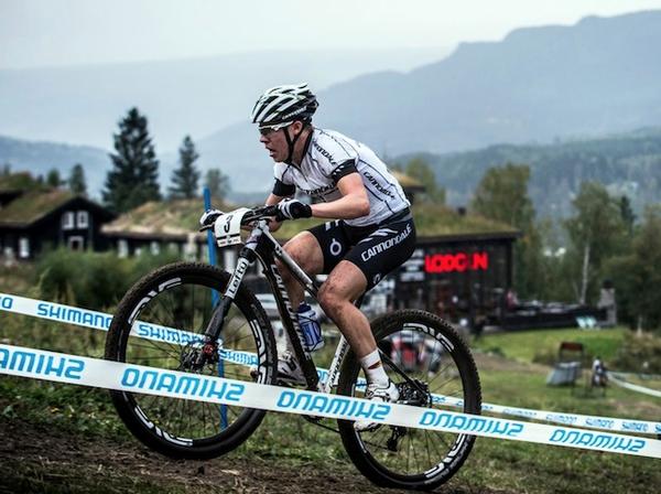 Anton Cooper powers up a muddy course at Hafjell, Norway today.